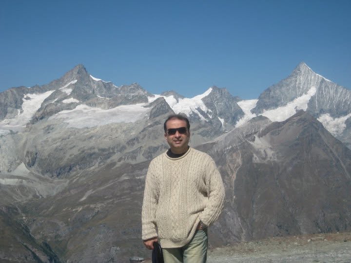 Umar Rafi in front of snow-capped mountains