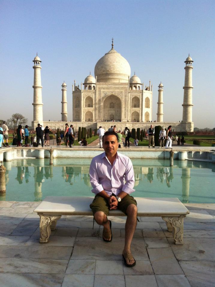 Umar Rafi seated in front of the Taj Mahal in India